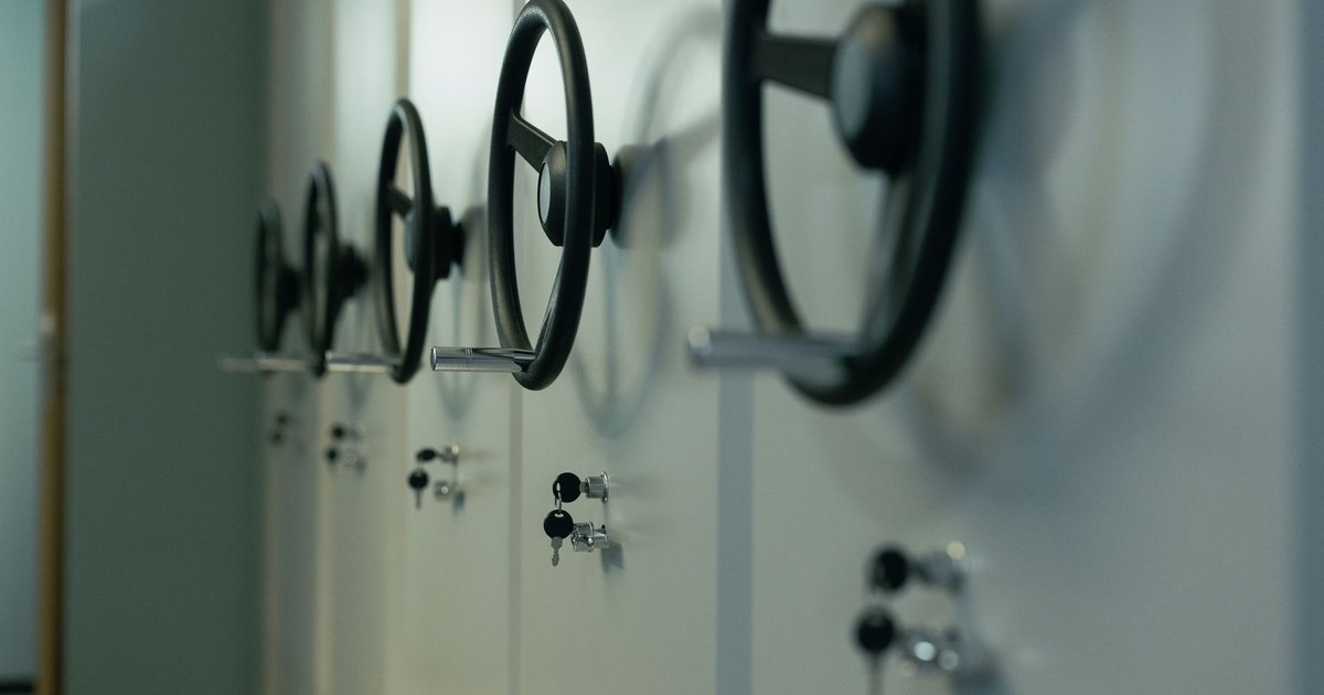 Close-up of a row of steel safes with round handles and key locks